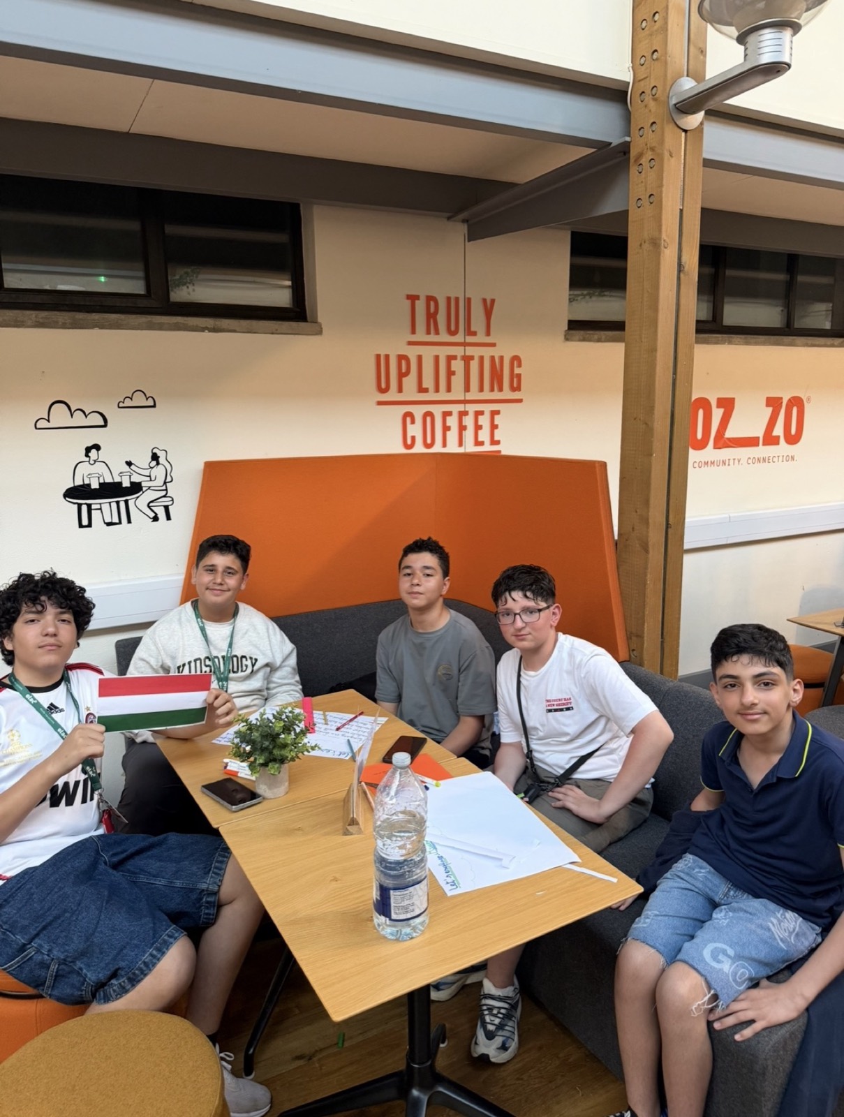 Teenage students around a table at the UK Summer Camp 2026